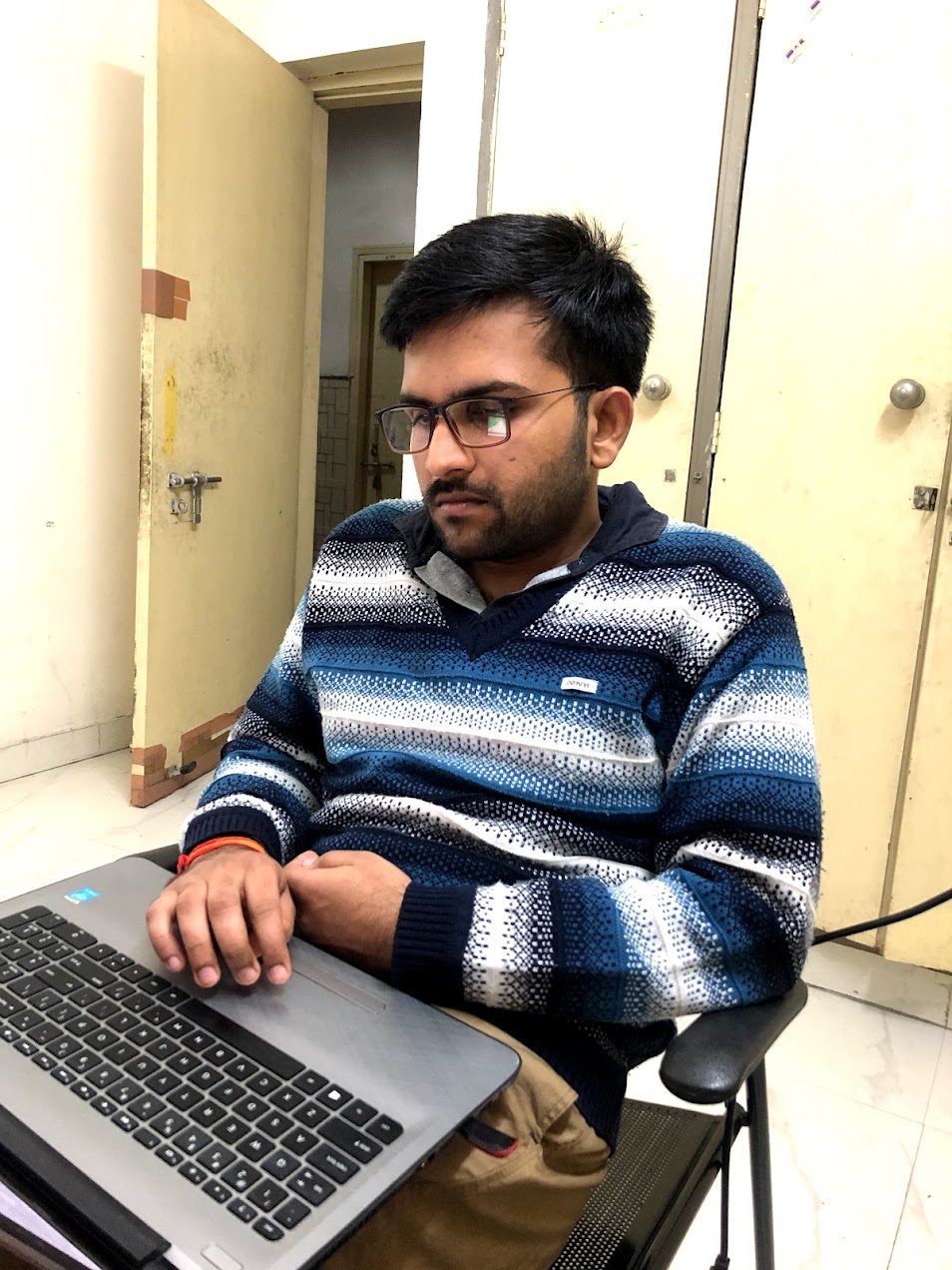 Sanyam Aggarwal reading from a laptop